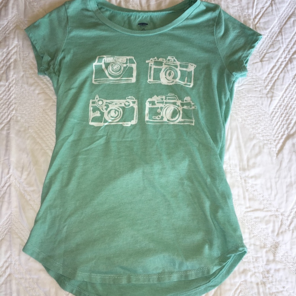 Teal shirt with cameras.